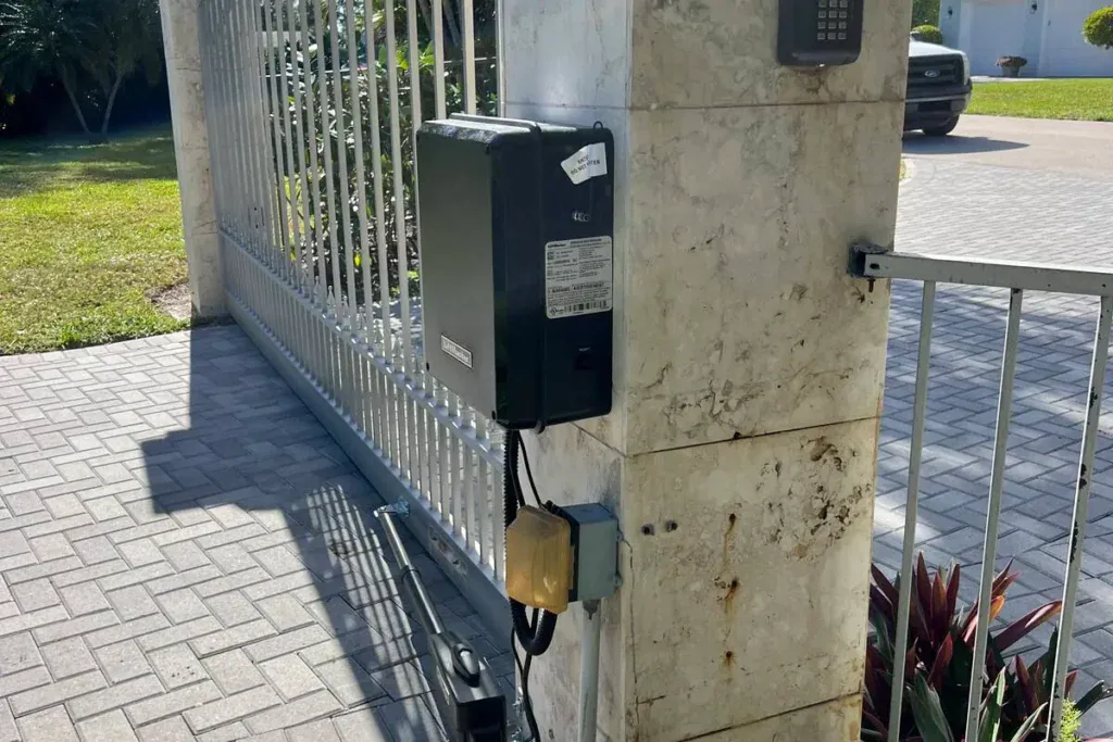 LiftMaster control box and swing-arm opener on a stone column