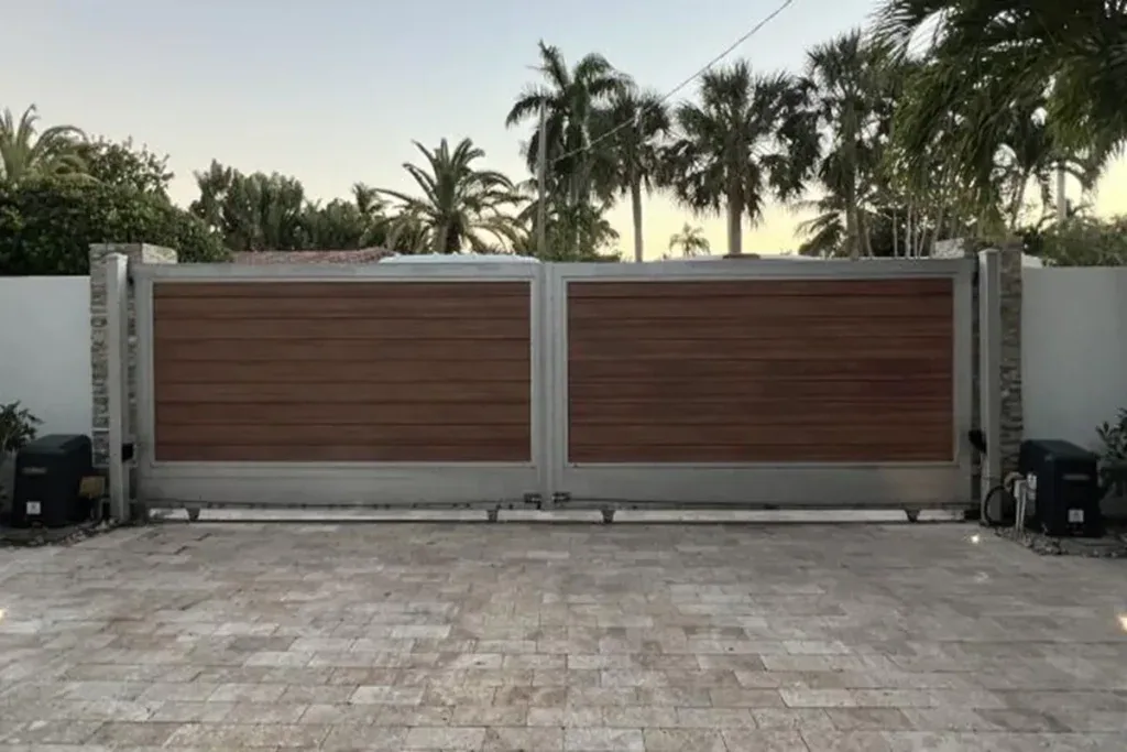 Gate operator mounted beside a driveway gate