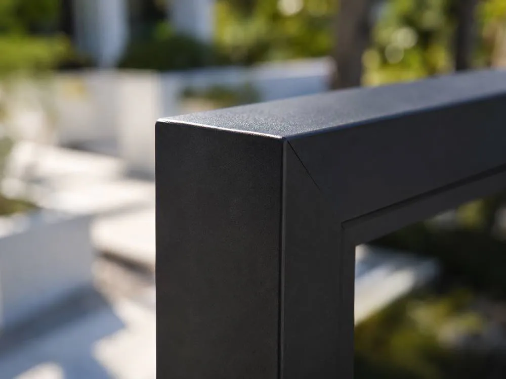 Close-up of a dark aluminum gate frame corner